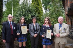 The 2 LVS winners Cora Merriman and Ava Murray with their English teacher. Club President, William Stokes to the right presented the awards and certificates. A presentation to the Junior winner, Anton Travin, was at the Junior School Assembly.